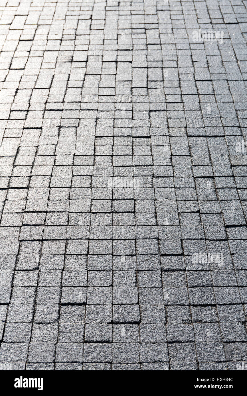 Granite cobblestone pavement of street surface background Stock Photo