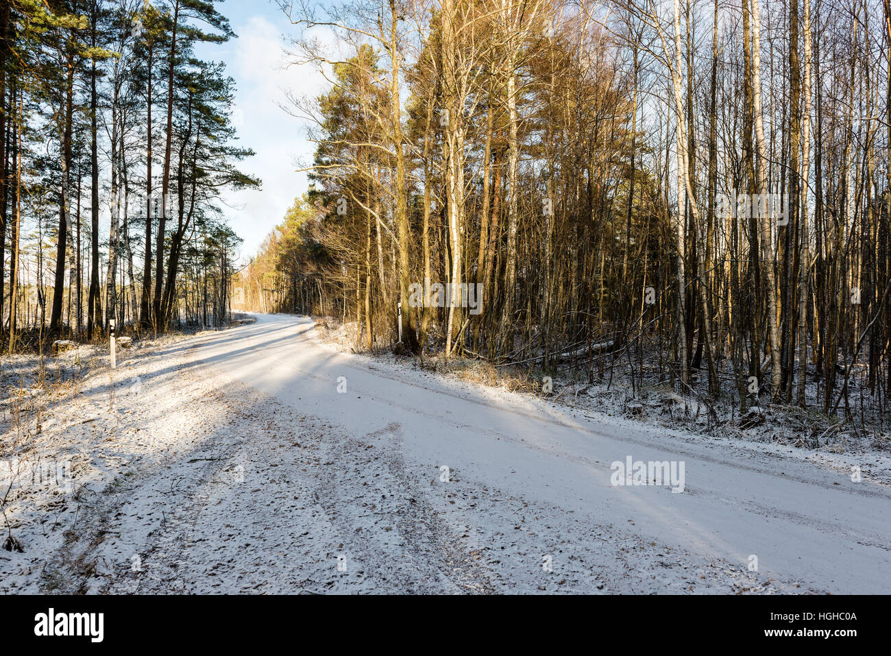 car tire tracks on winter road in deep snow in lonely forest Stock ...