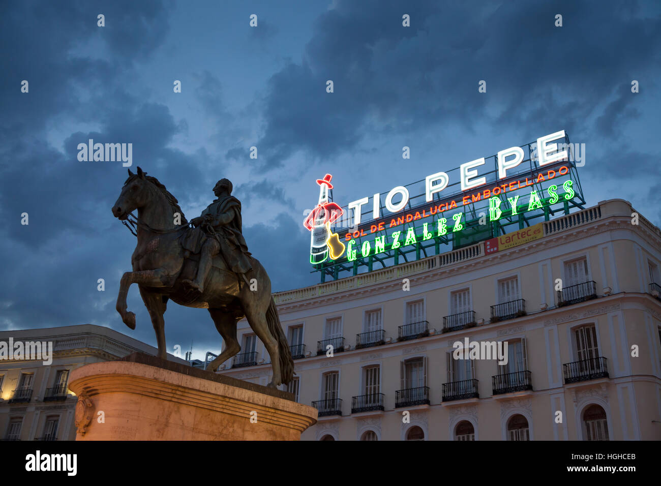Madrid, Spain: Equestrian statue of Charles III of Spain with the landmark Tío Pepe sign in the Puerta del Sol. Stock Photo