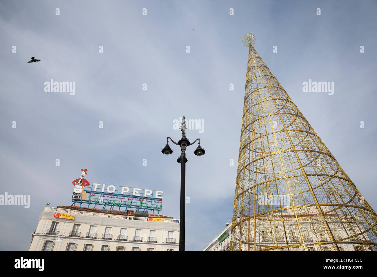 Madrid, Spain: Modern Christmas tree with the landmark Tío Pepe sign in the Puerta del Sol. Stock Photo