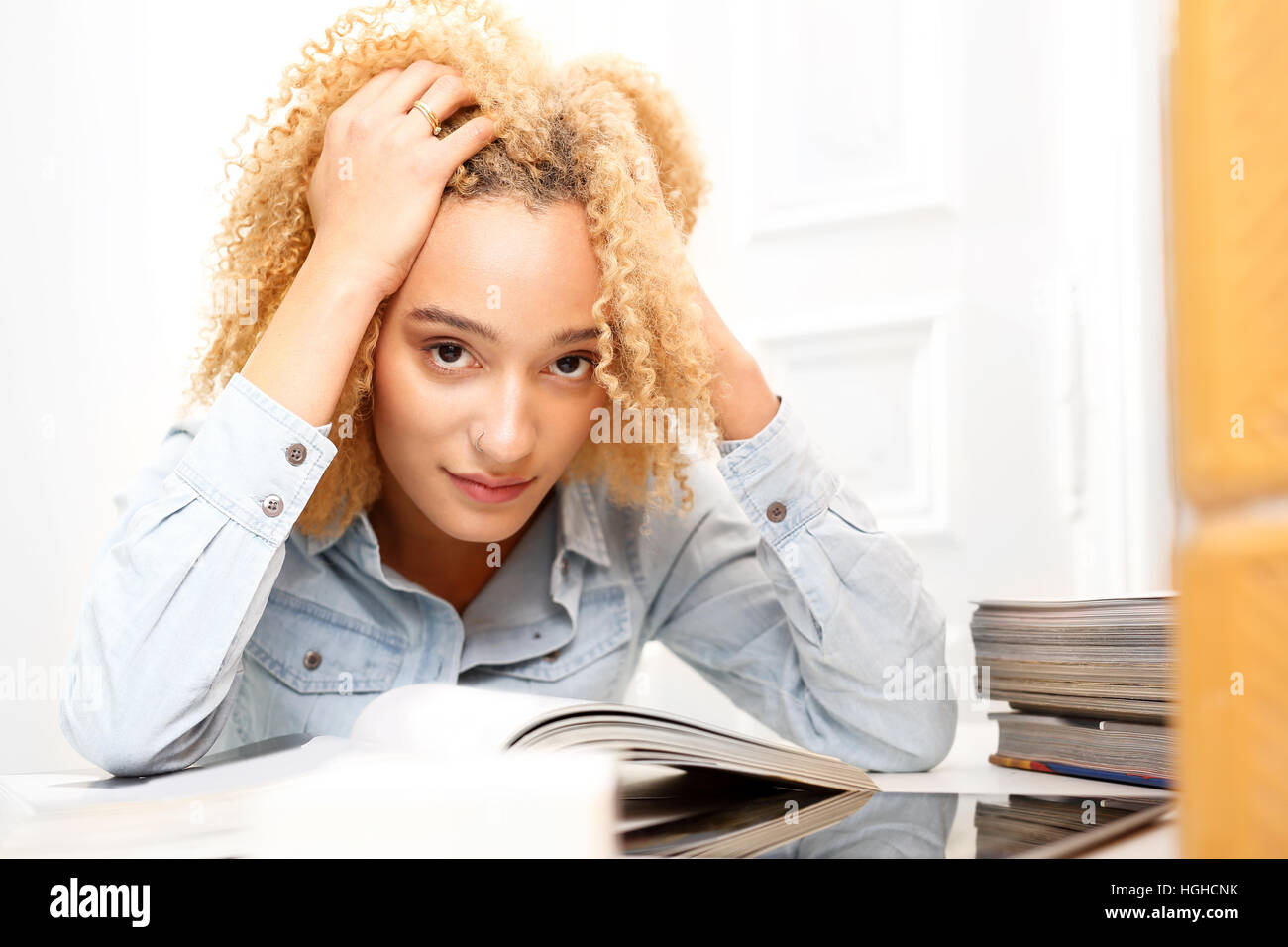 Education. Teenager learns to test. A young girl learns to test, reads the note. Stock Photo