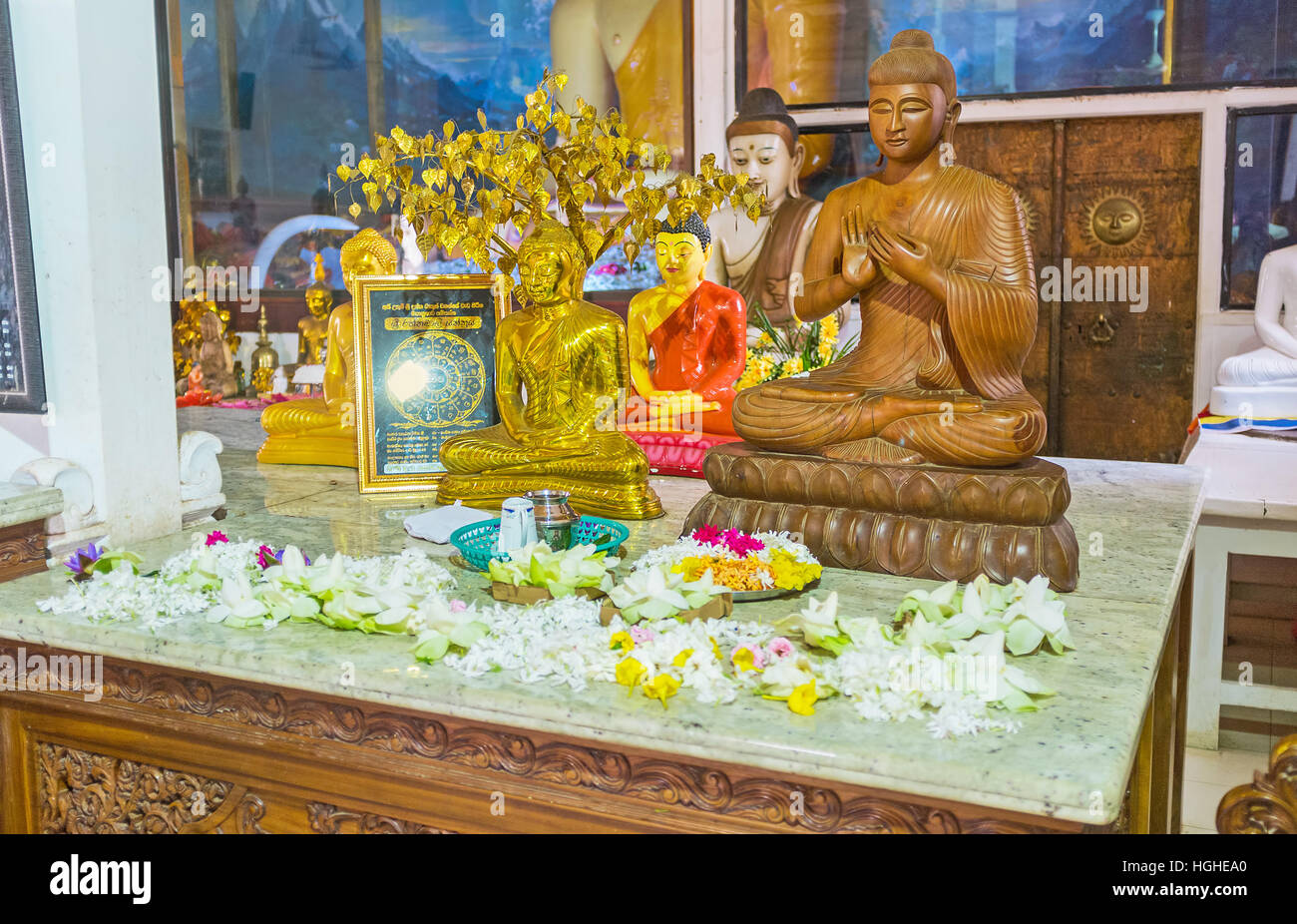 The altar in Image House of Bodhi Tree Temple with small sculptures of  Buddha and lotus flowers Stock Photo - Alamy
