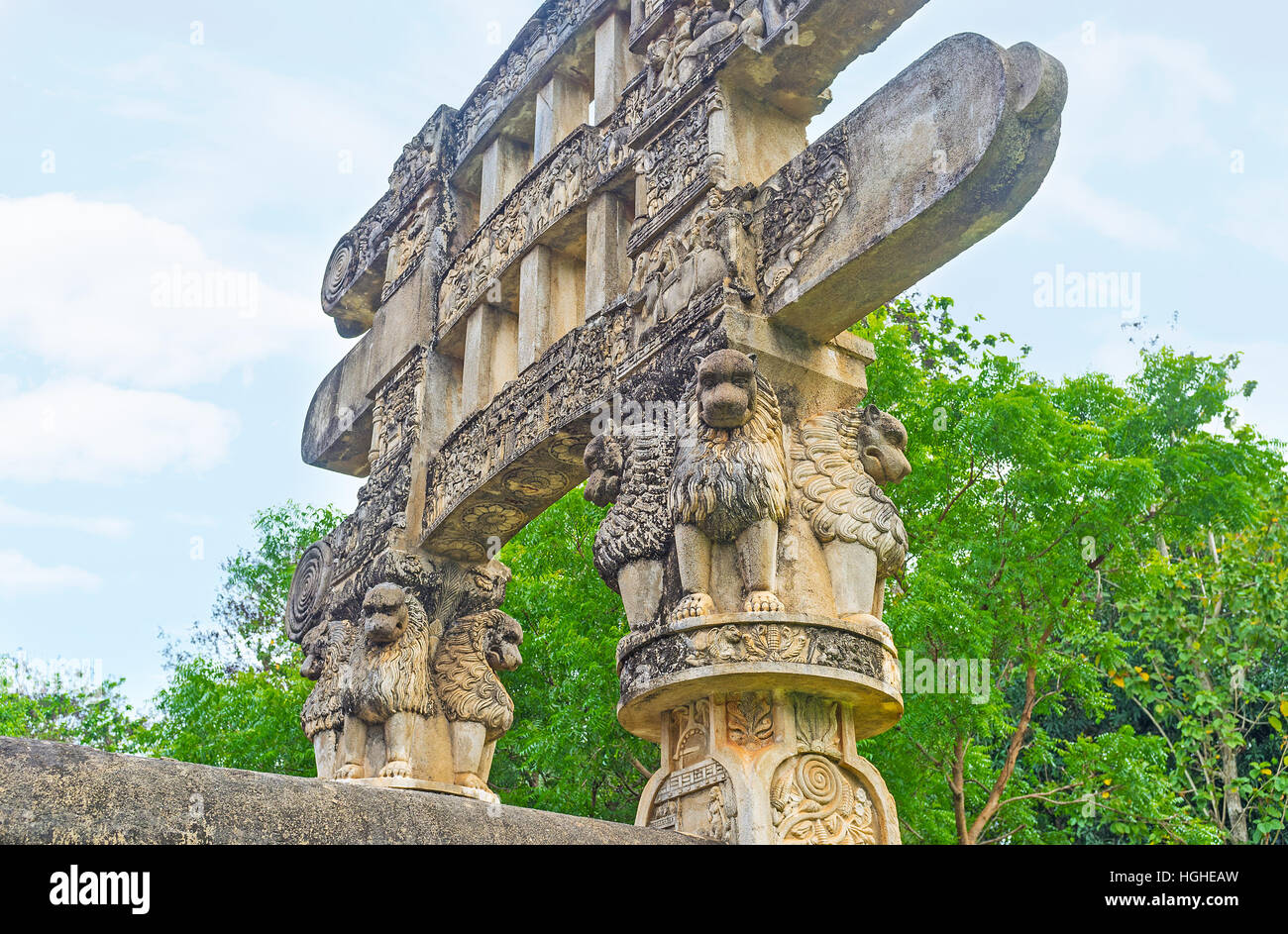 The Torana Gate of Mihintale replica of Great Sanchi Stupa decorated with lions, sitting under the beams of gateway and holding them, Sri Lanka. Stock Photo