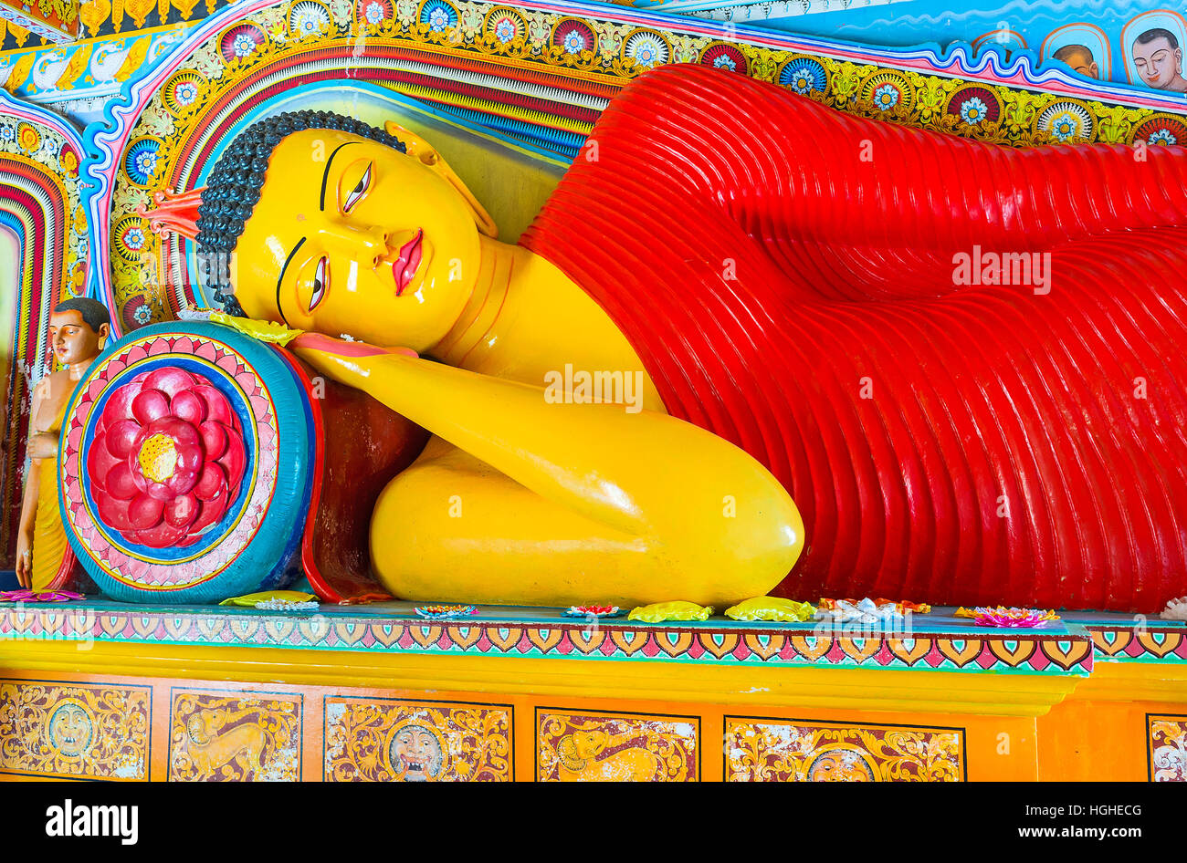 The Reclining Buddha in Isurumuniya Rock Temple, surrounded by painted