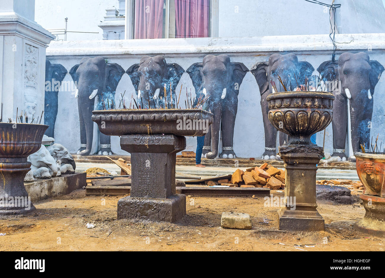The stone vases and bowls with incense sticks at the Ruwanwelisaya complex, Anuradhapura, Sri