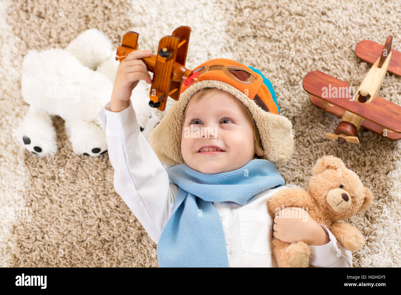 Happy kid boy playing with toy airplane Stock Photo - Alamy