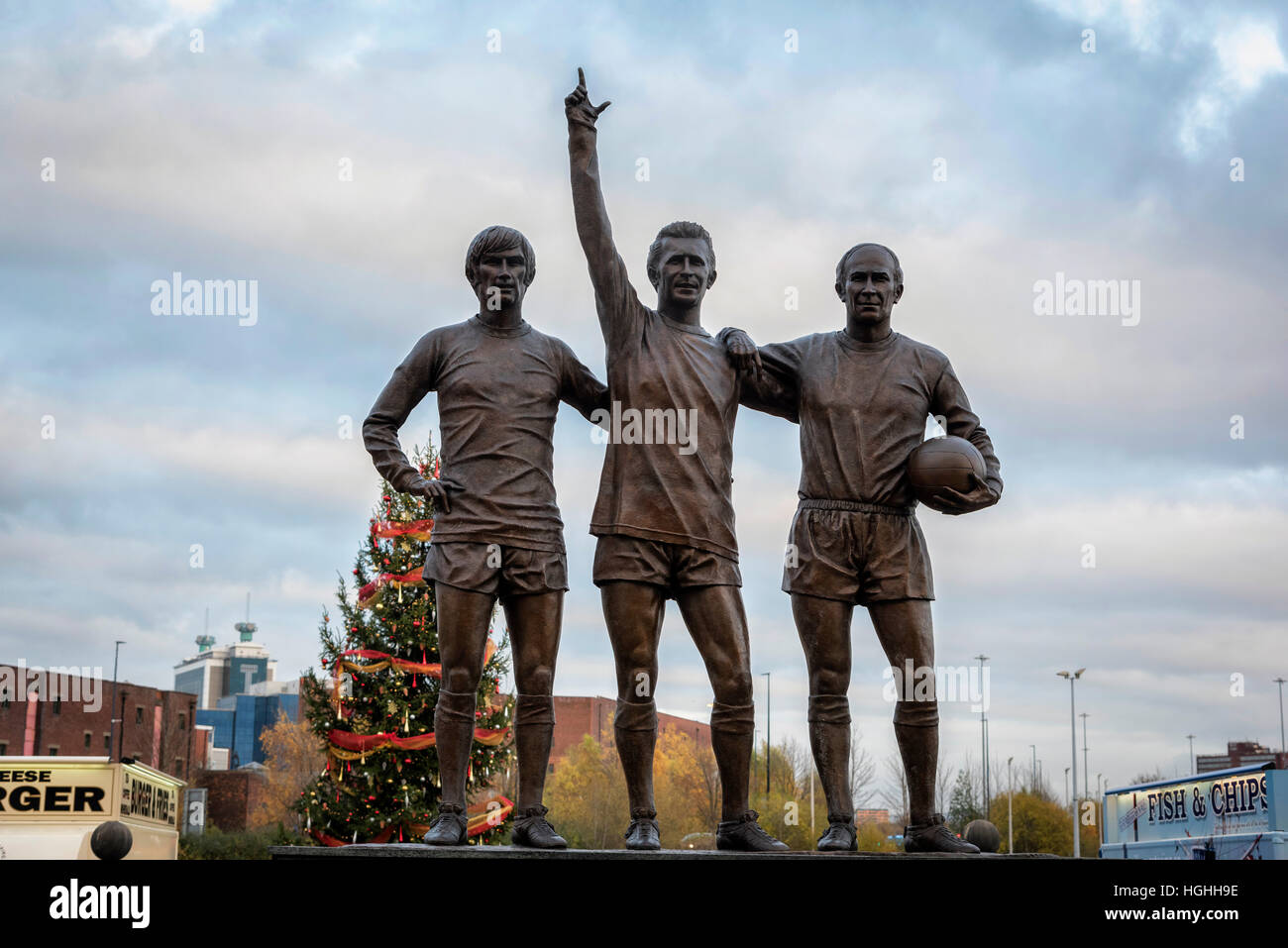 George Best Denis Law Bobby Charlton statue at Manchester United Stock Photo