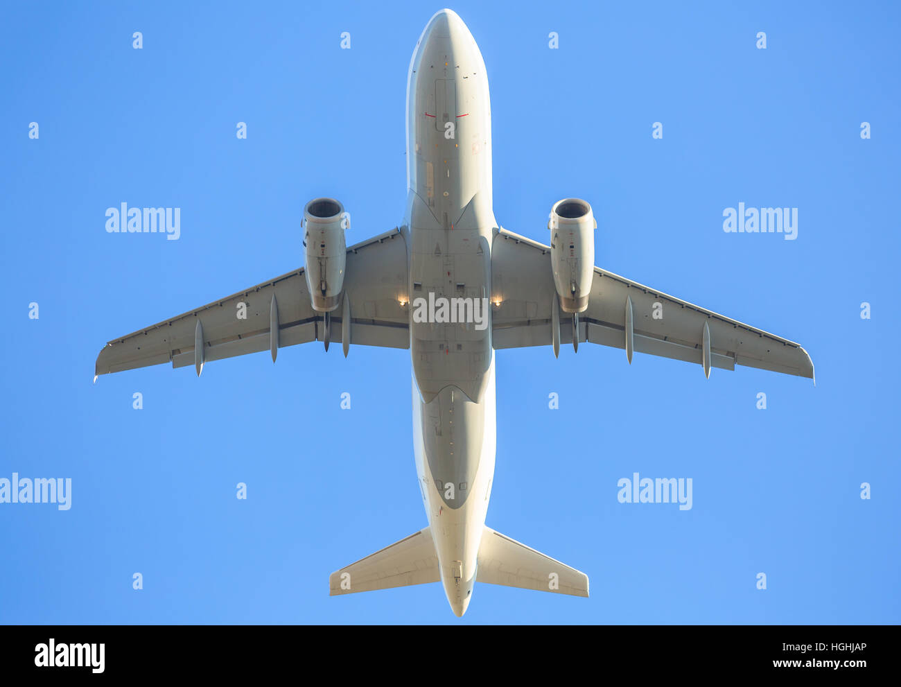 behind white airplane in the sky Stock Photo