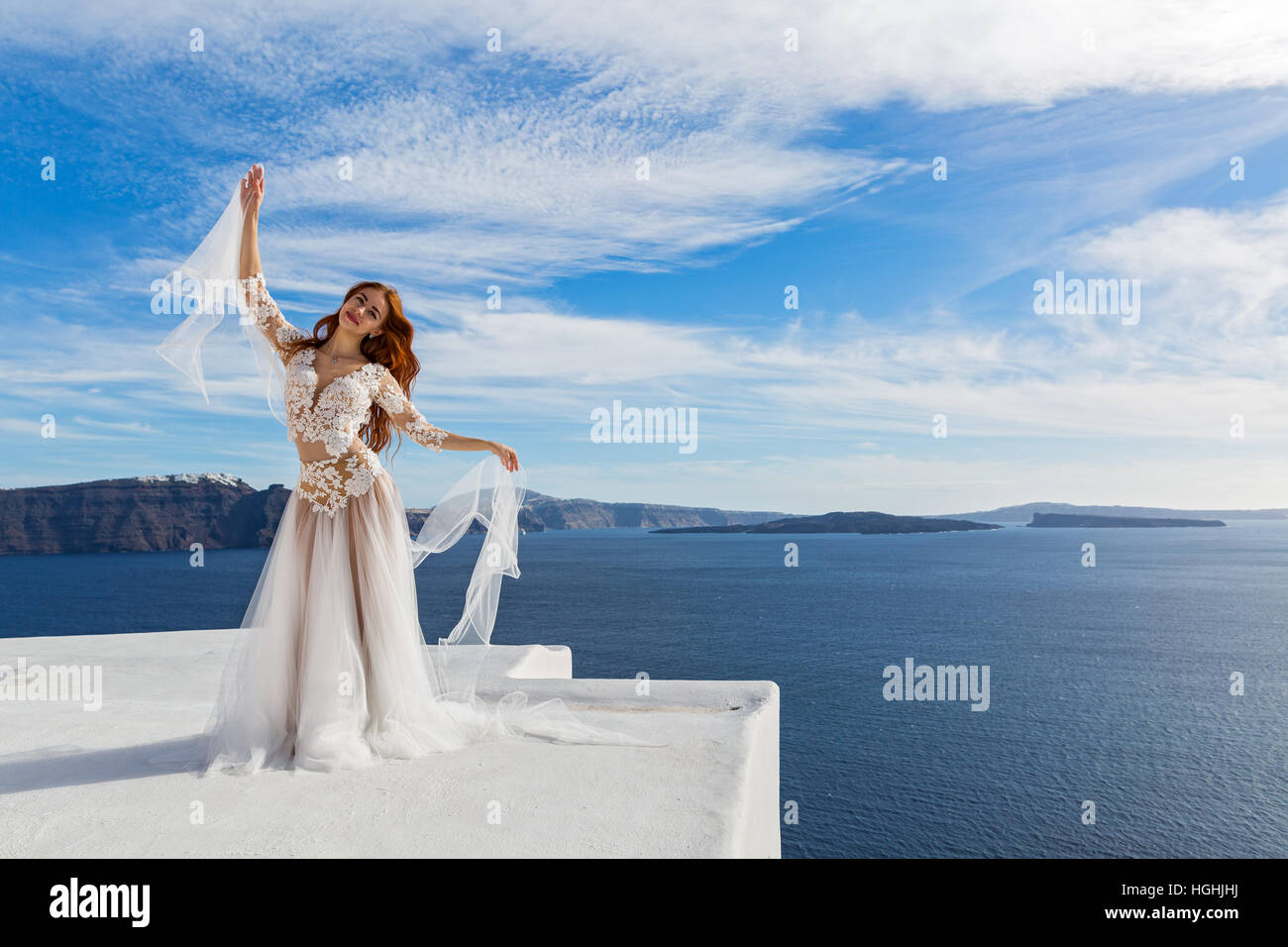 Beautiful young woman in white dress and island Santorini Stock Photo ...