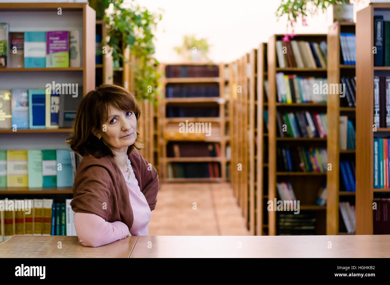 Day in library with books, student, librarians, computers and laptops ...