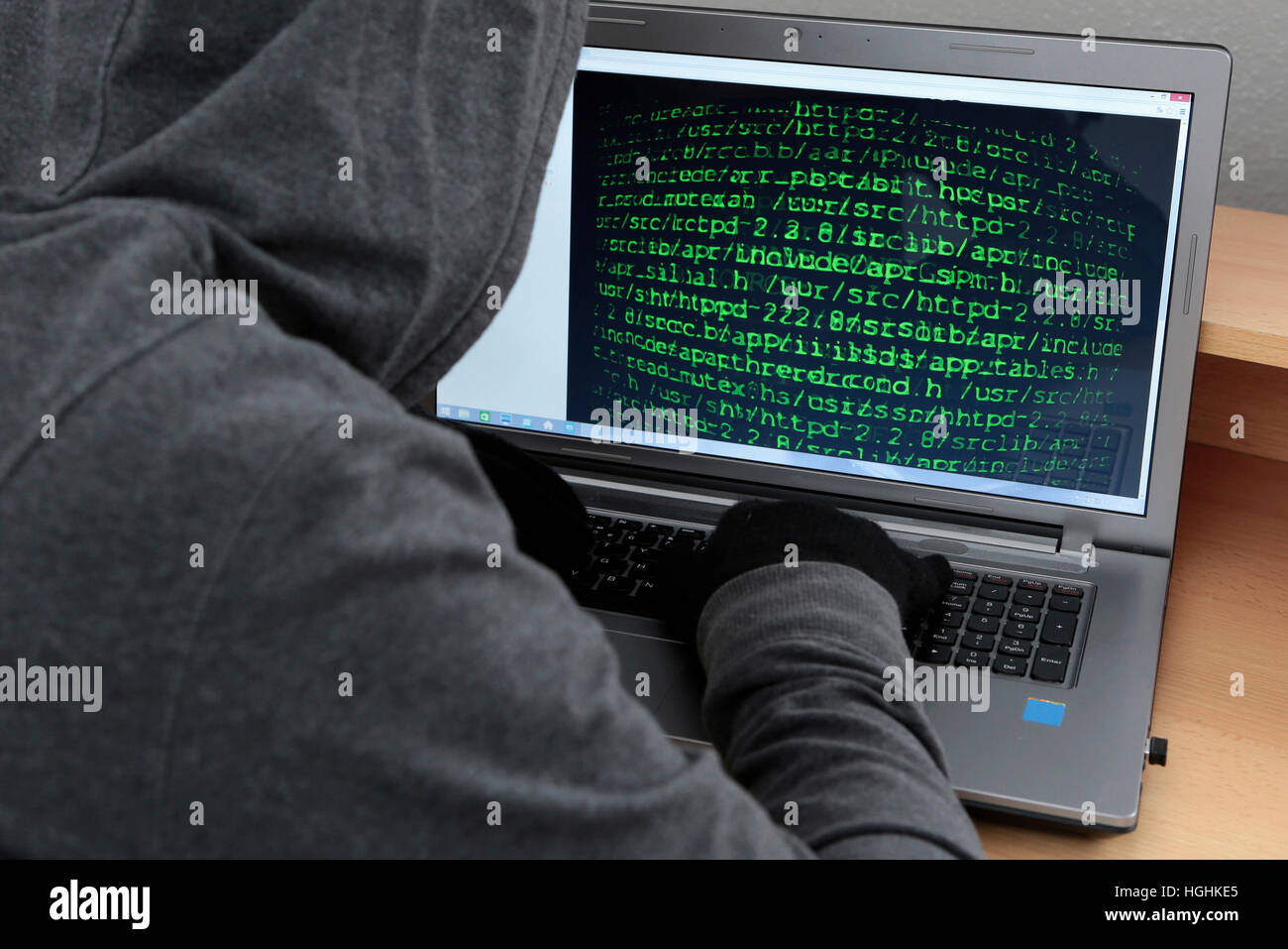 Unrecognizable hacker in front of computer – cybercrime concept Stock Photo