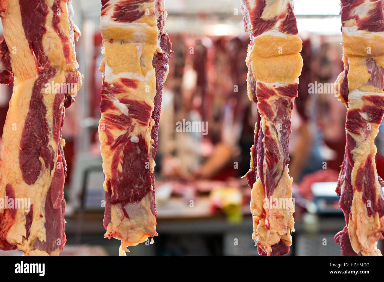 Meat hanging in the meat market Stock Photo