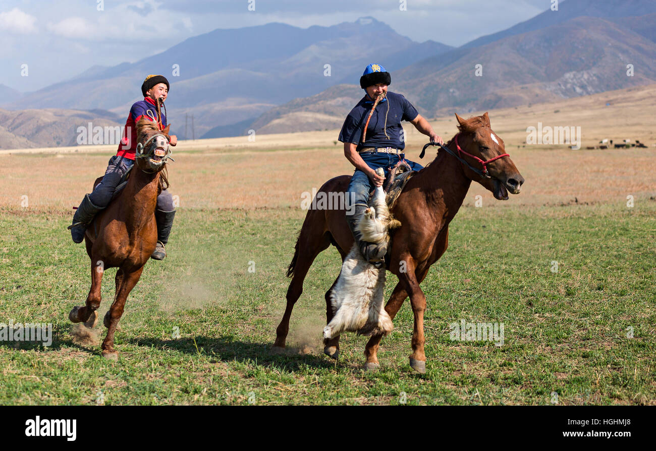 Kazakh men play the nomadic horse game known as Kokpar or Buzkashi in Aksu, Zhabagly, Kazakhstan Stock Photo