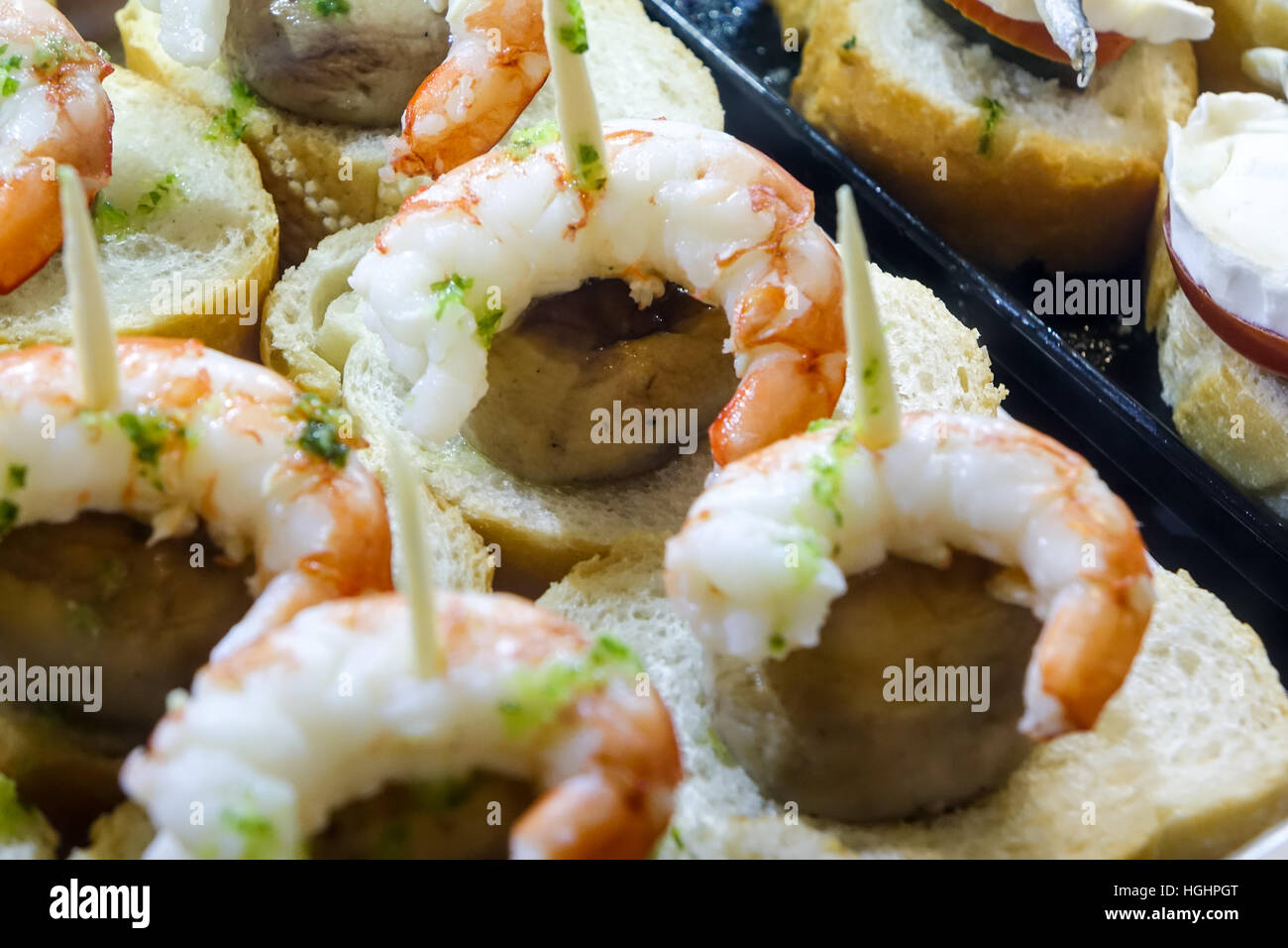 Tapas on display in glass cases on Spanish bar Stock Photo Alamy