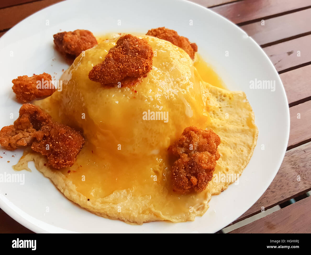 Close-up,Thai food style:scrambled omlette eggs with spicy chicken on rice Stock Photo