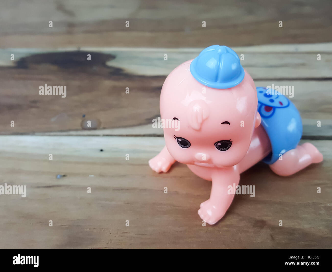 Mechanical wind up crawling baby toy on wood background Stock Photo Alamy