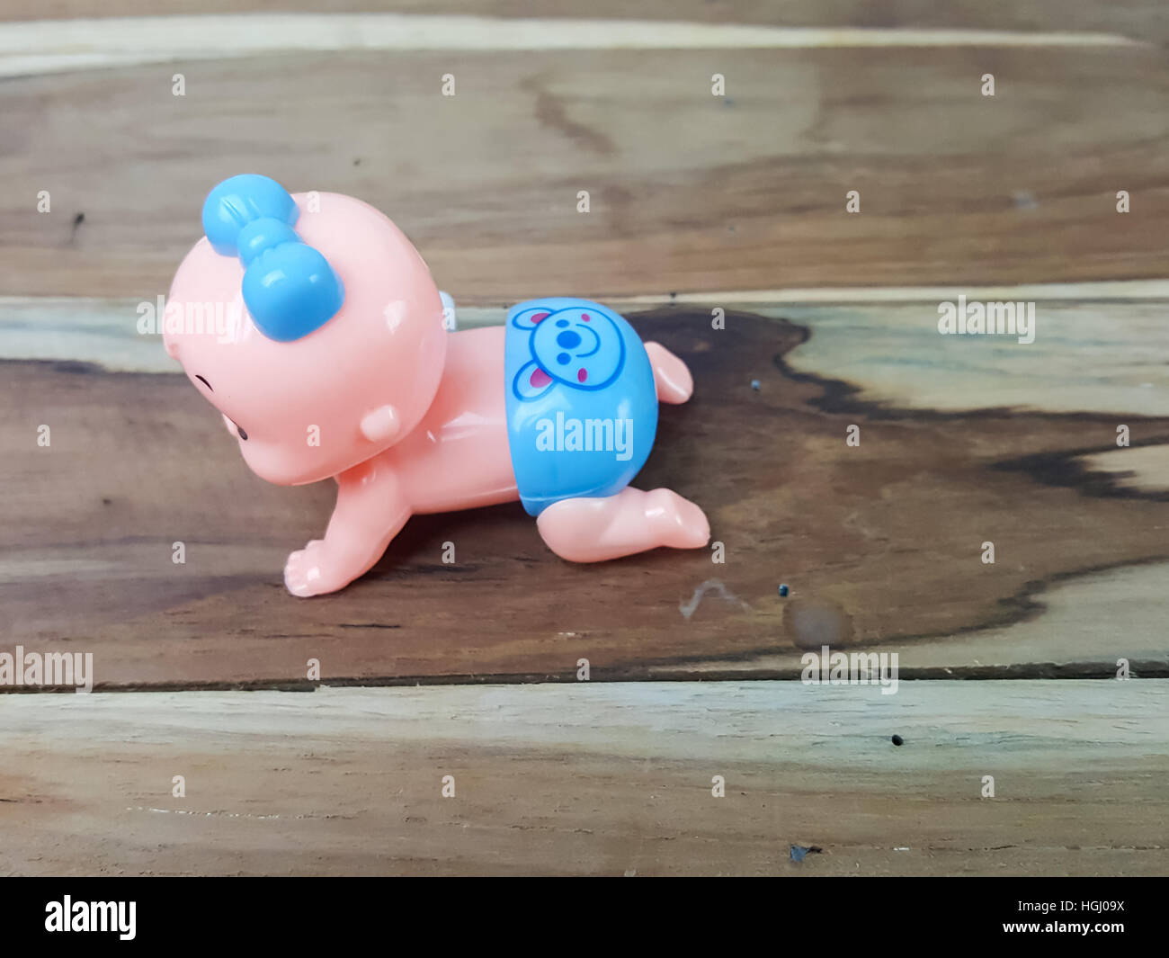 Mechanical wind up crawling baby toy on wood background Stock Photo Alamy