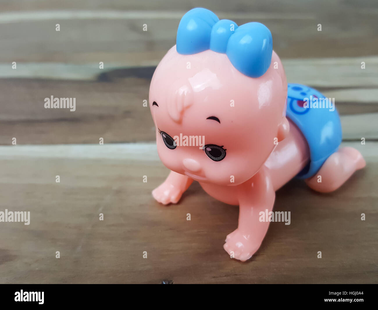 Mechanical wind up crawling baby toy on wood background Stock Photo Alamy