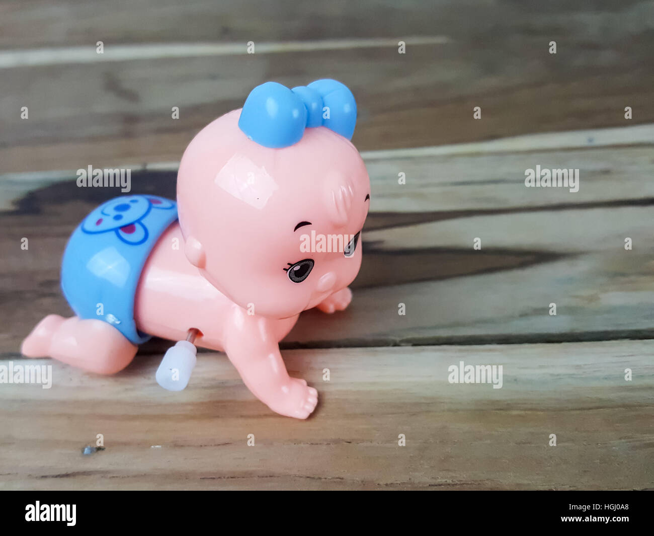 Mechanical wind up crawling baby toy on wood background Stock Photo Alamy