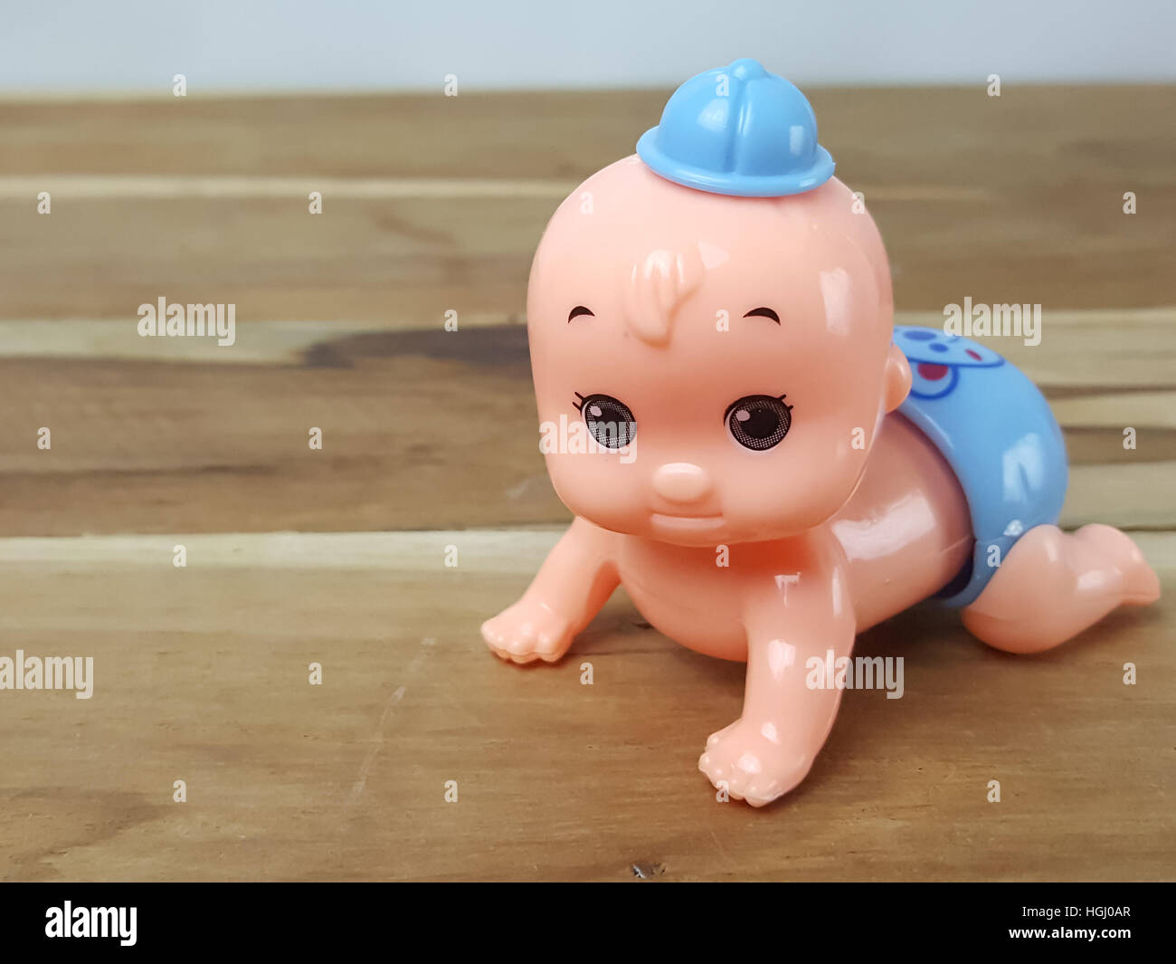 Mechanical wind up crawling baby toy on wood background Stock Photo Alamy