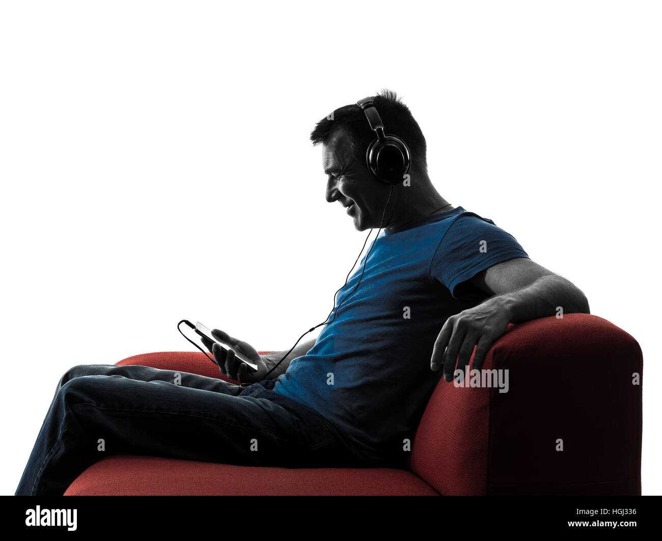 one caucasian man sofa couch listening music audio in silhouette