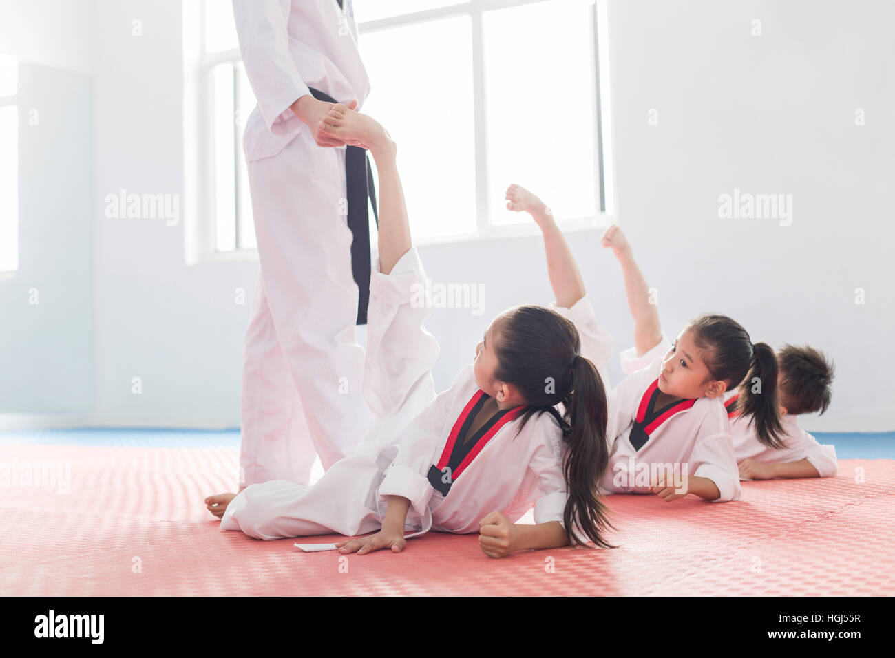 Young instructor teaching children Tae Kwon Do Stock Photo