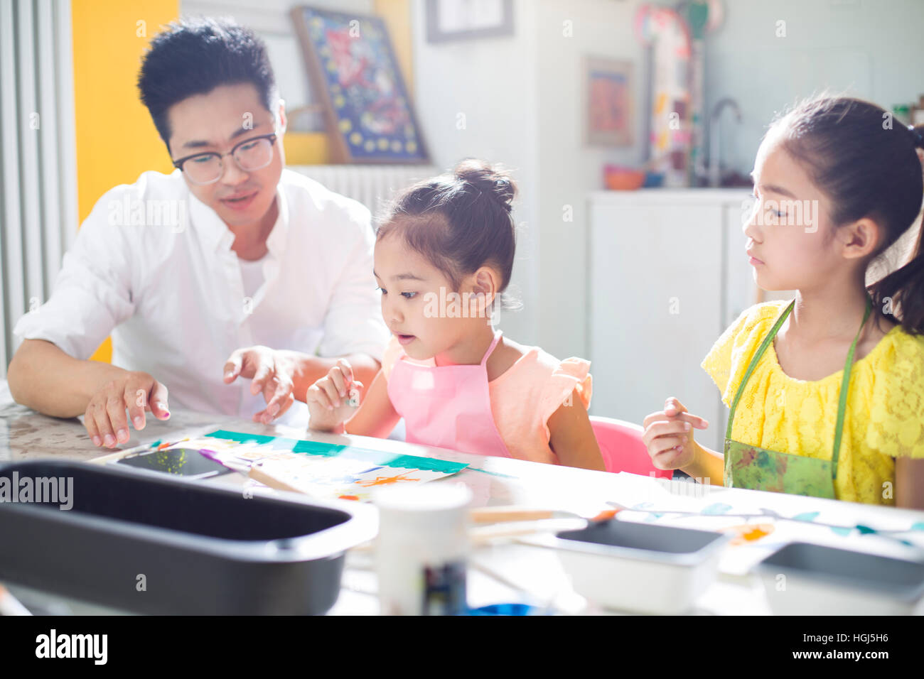 Little children painting in art class with teacher Stock Photo - Alamy