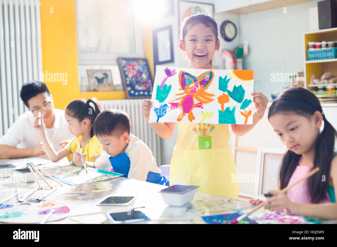 Teacher with children paintings hi-res stock photography and images - Alamy