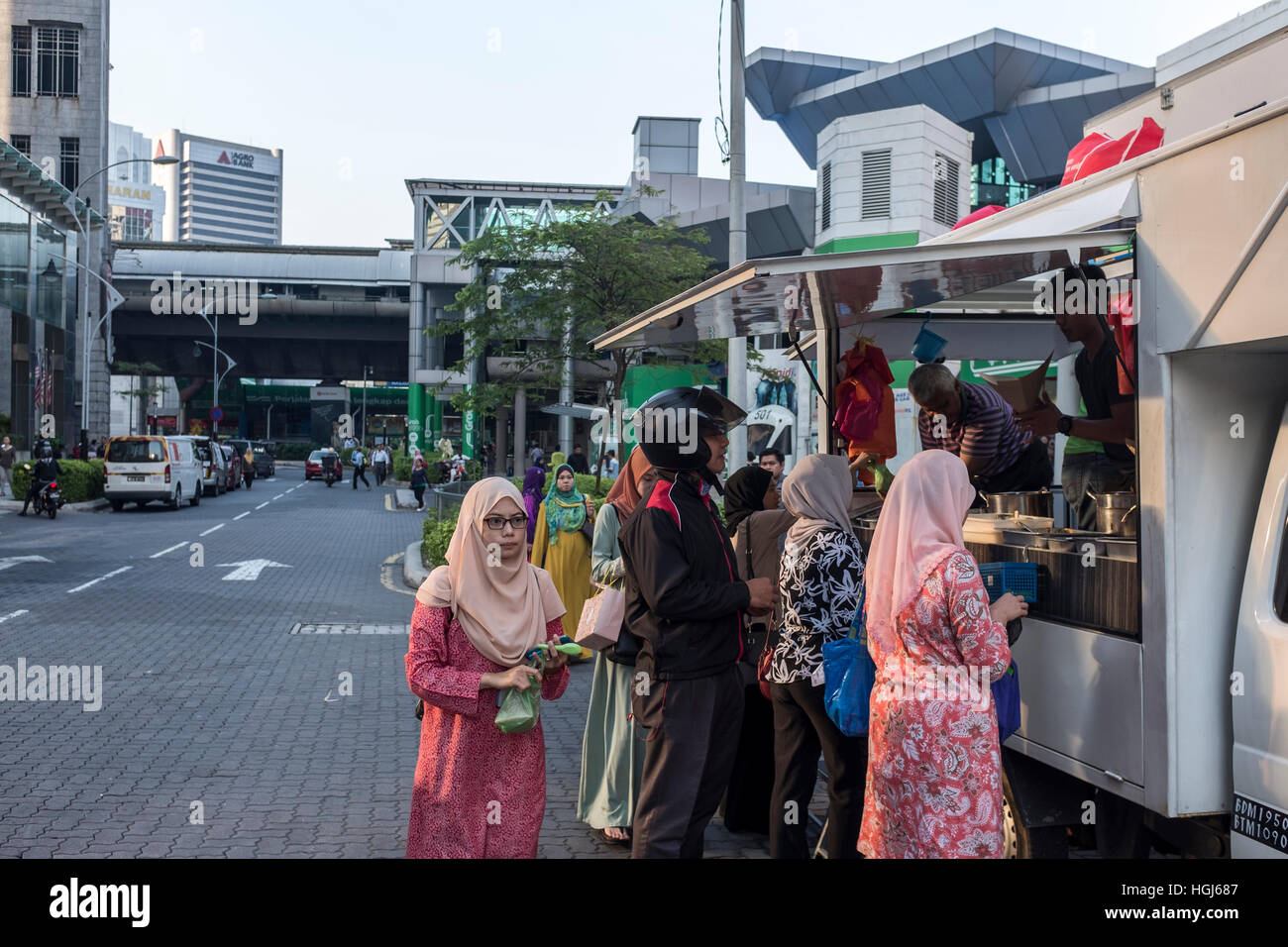 Customers line up to buy food at a food truck in Kuala Lumpur, Malaysia