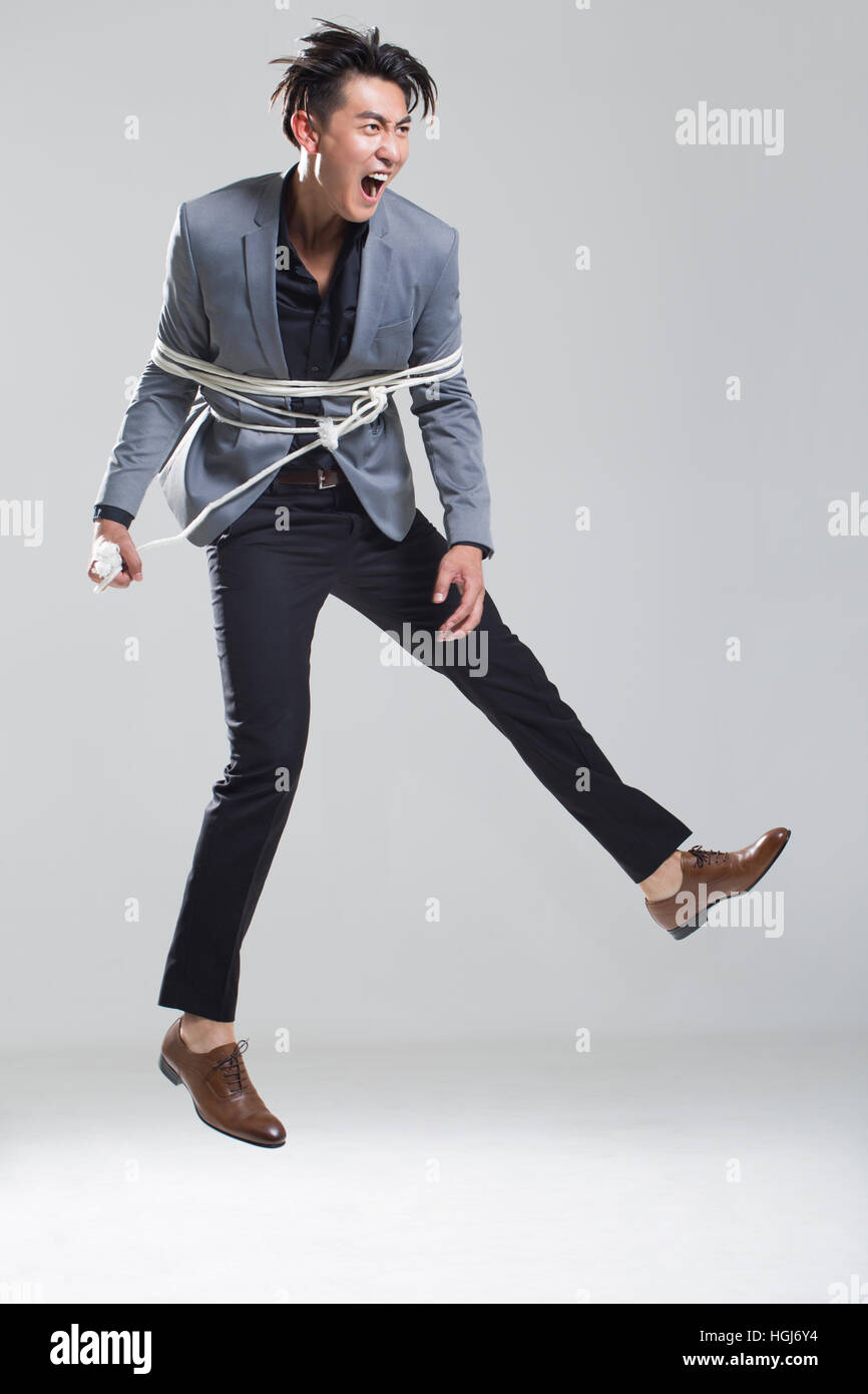 Young man tied up with rope Stock Photo
