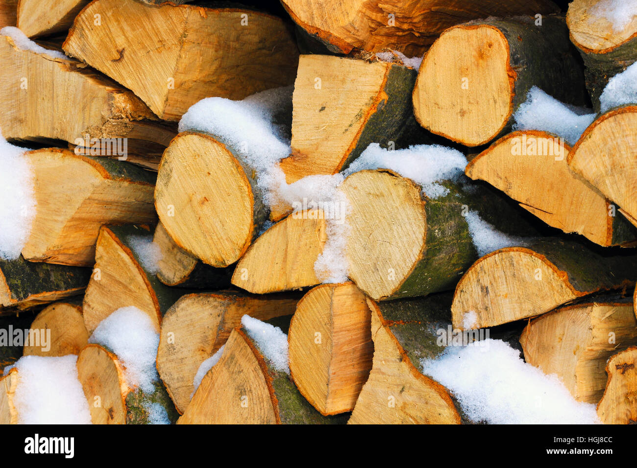 Stacked firewood in winter under the snow Stock Photo Alamy