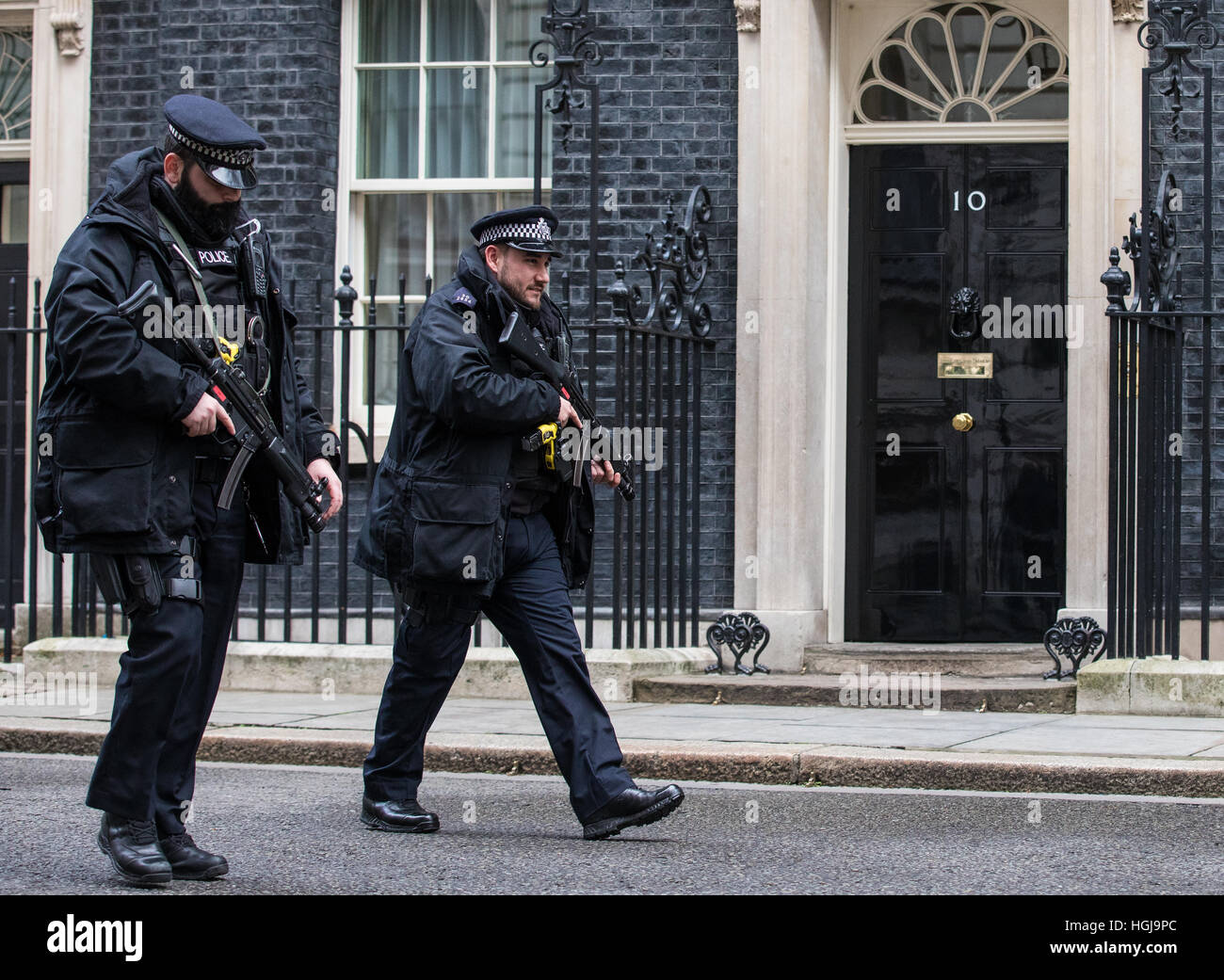 Armed police patrol outside No 10 Downing Street in London. Stock Photo