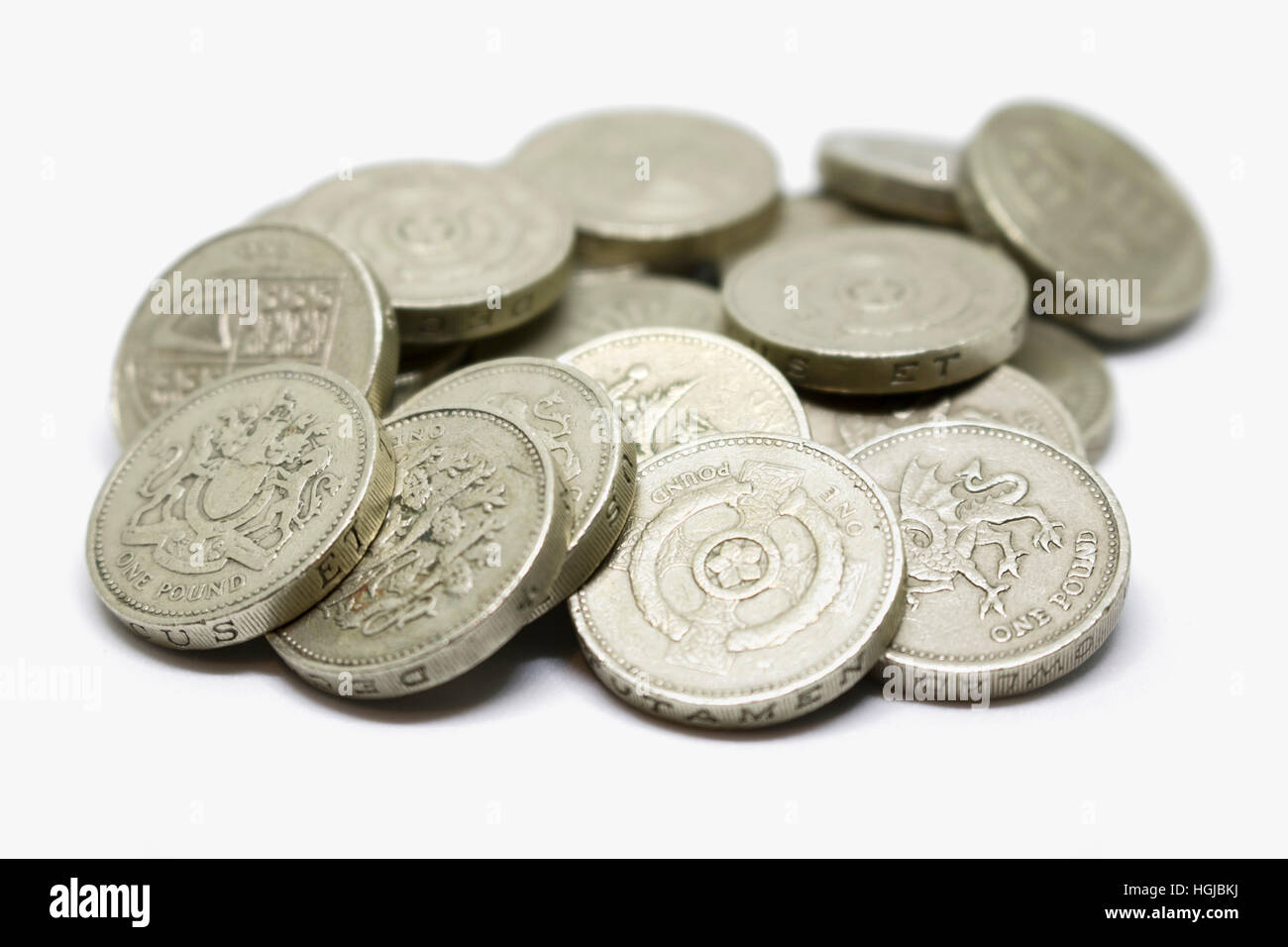 Pile of British 1 pound coins in a pile on an isolated white background Stock Photo