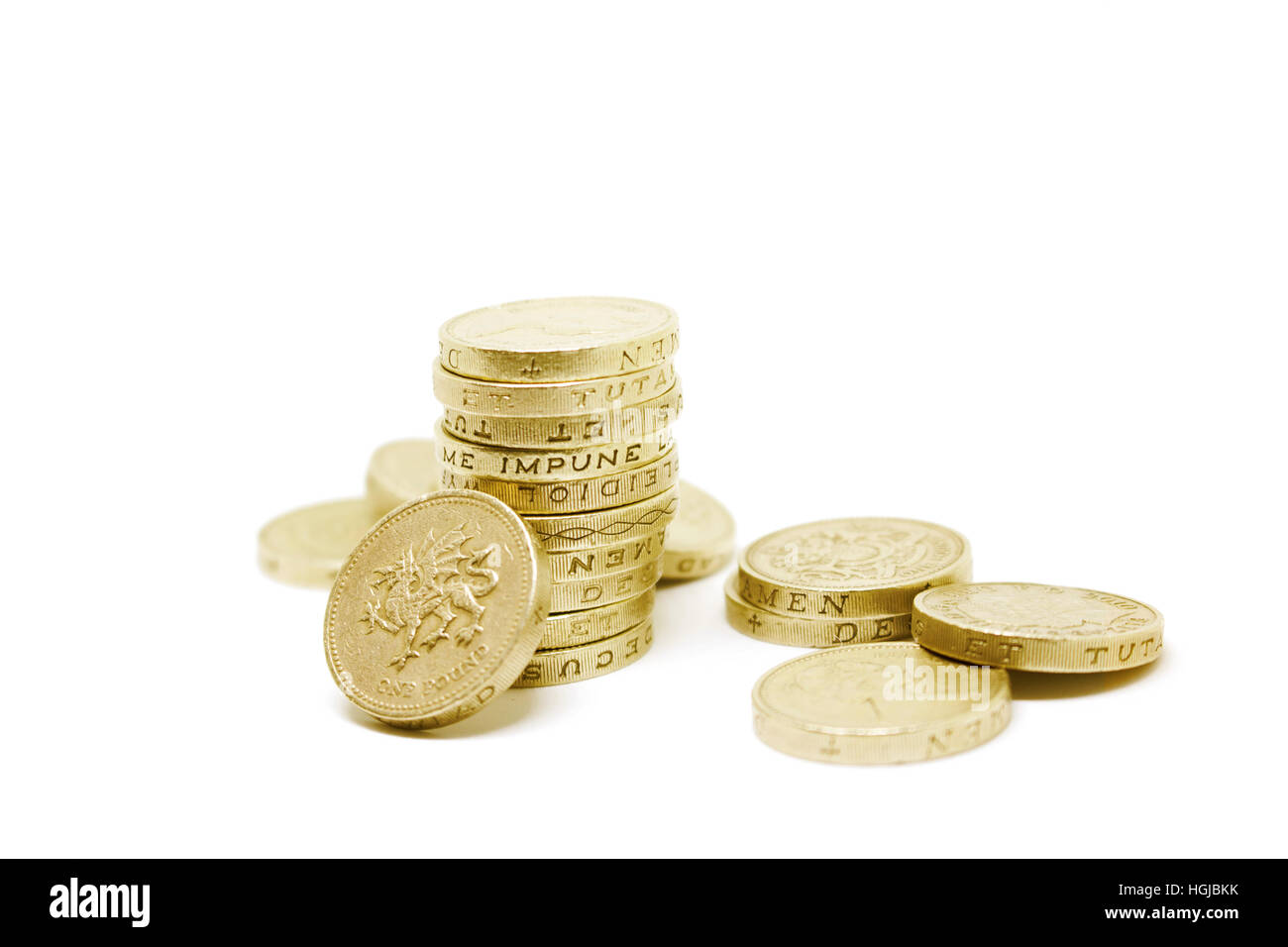 Stack of British 1 pound coins in a pile on an isolated white background Stock Photo