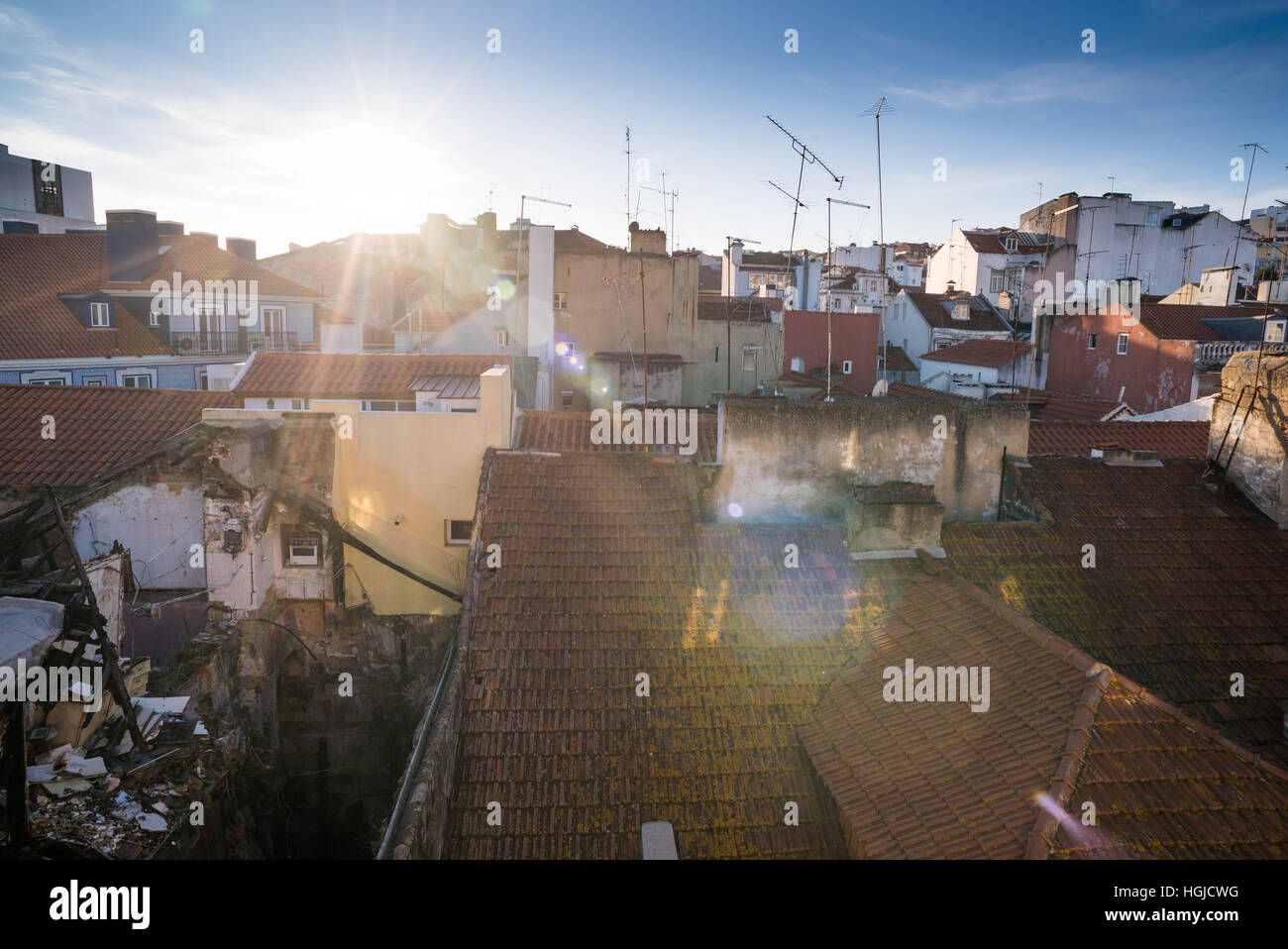 a burnt out house sits among run down houses in Bairro Alto Stock Photo