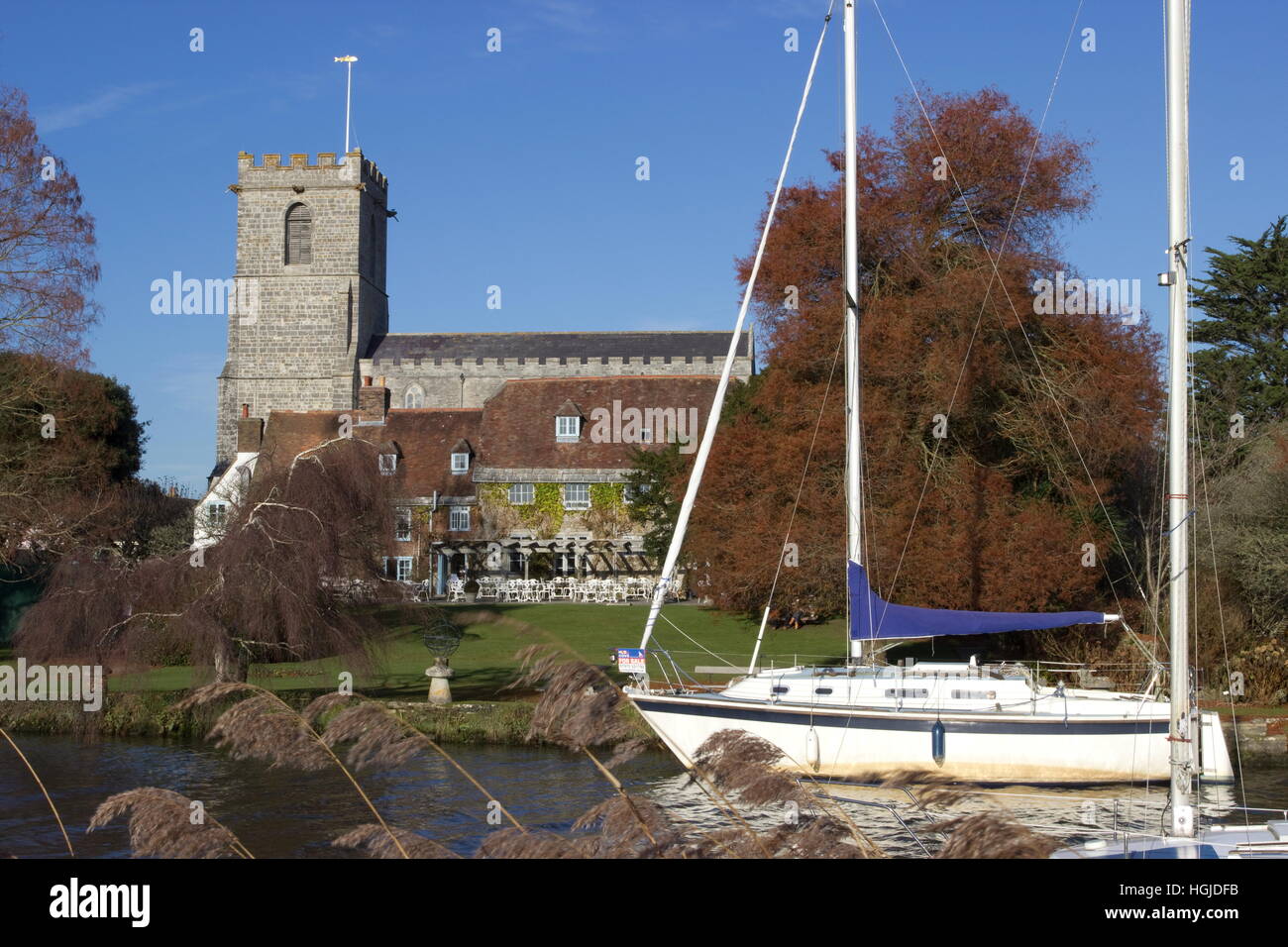 Lady St Mary Church and sail boats River Frome on a sunny Winter's day Wareham Dorset Stock Photo