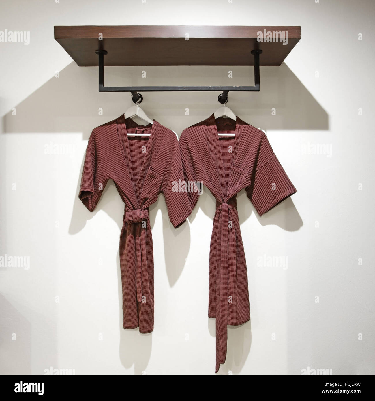 Bath Robe Hanger Rack two off brown bathrobes hanging on rack Stock Photo - Alamy