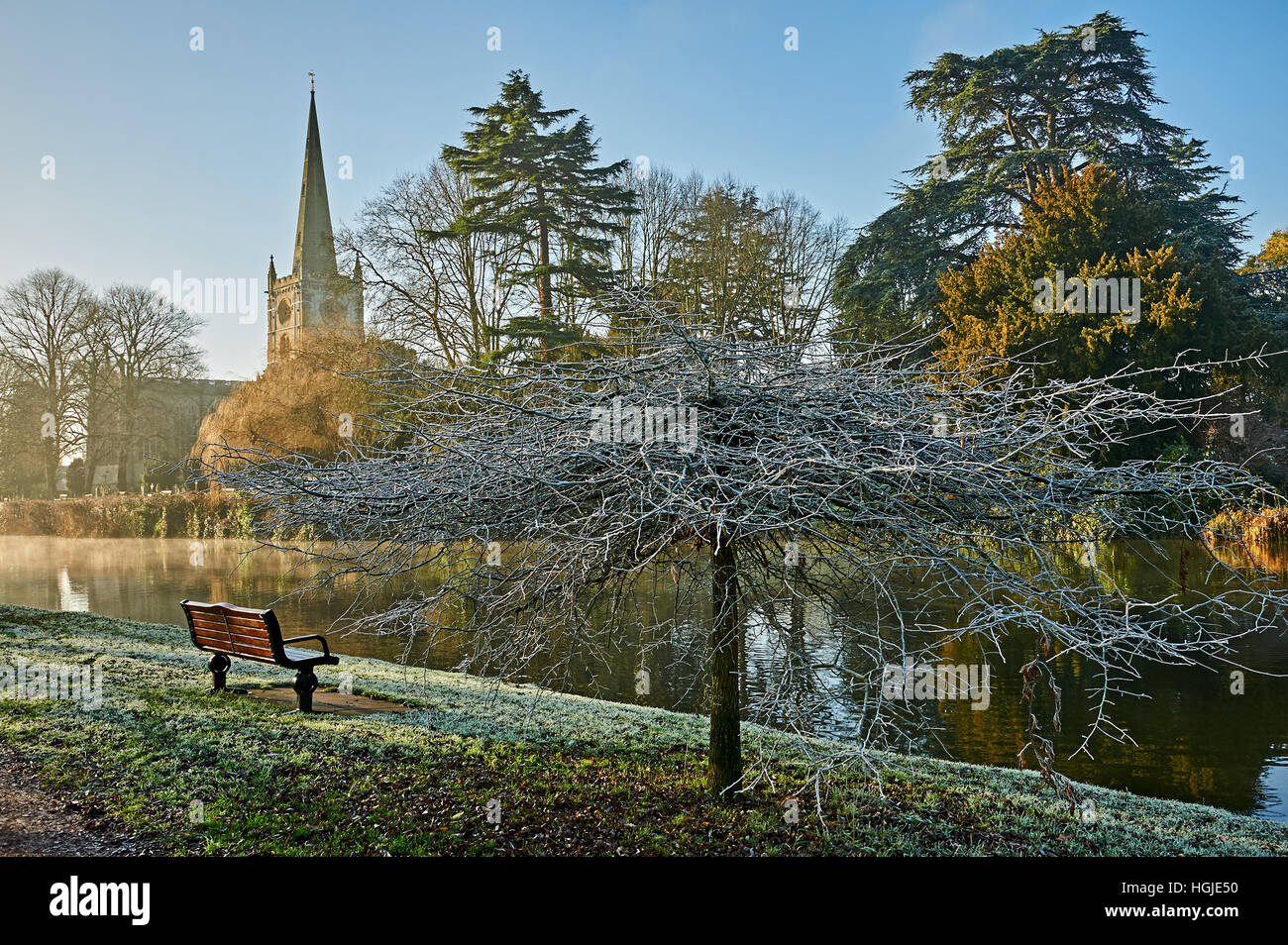 Holy Trinity church in Stratford upon Avon is the burial place of William Shakespeare and stands on the banks of the River Avon on a winter morning. Stock Photo