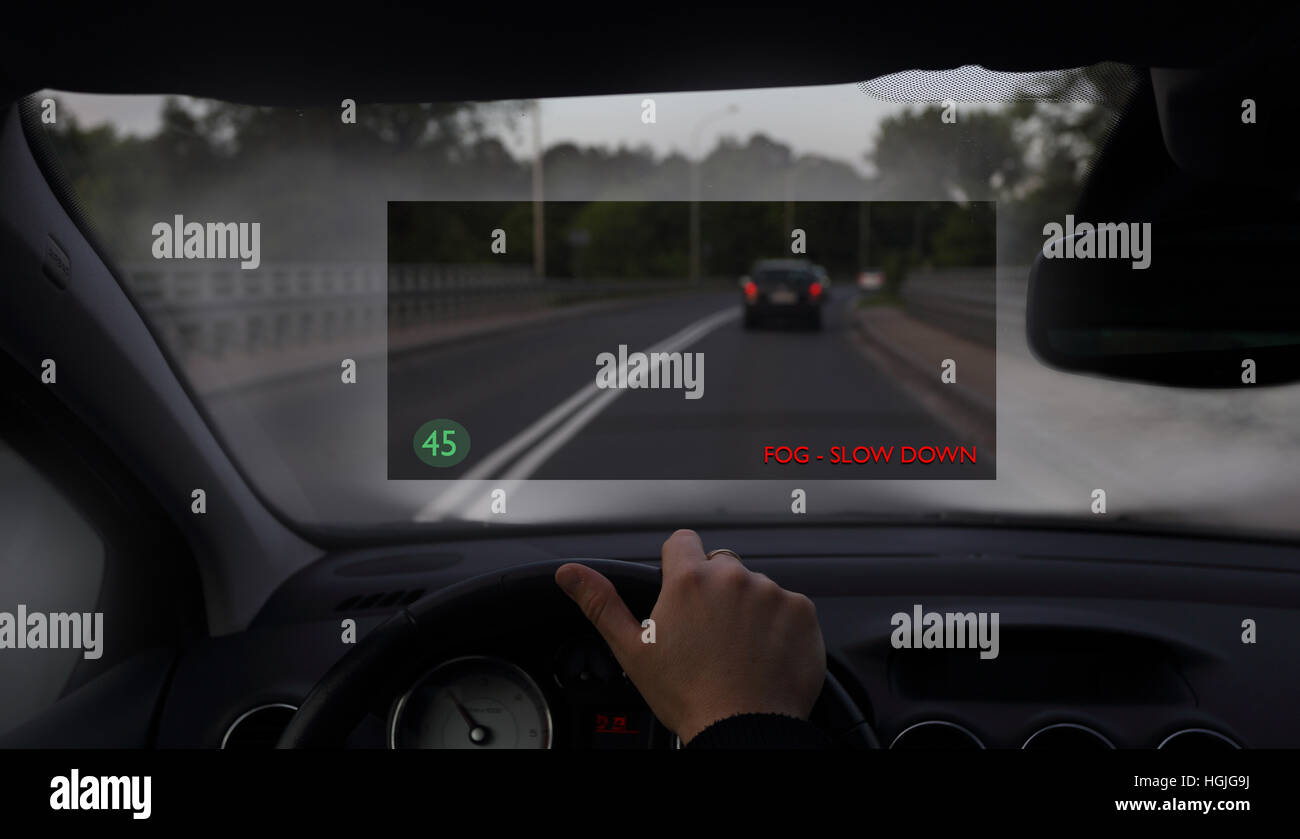 Driving car in the fog with a head up display system Stock Photo