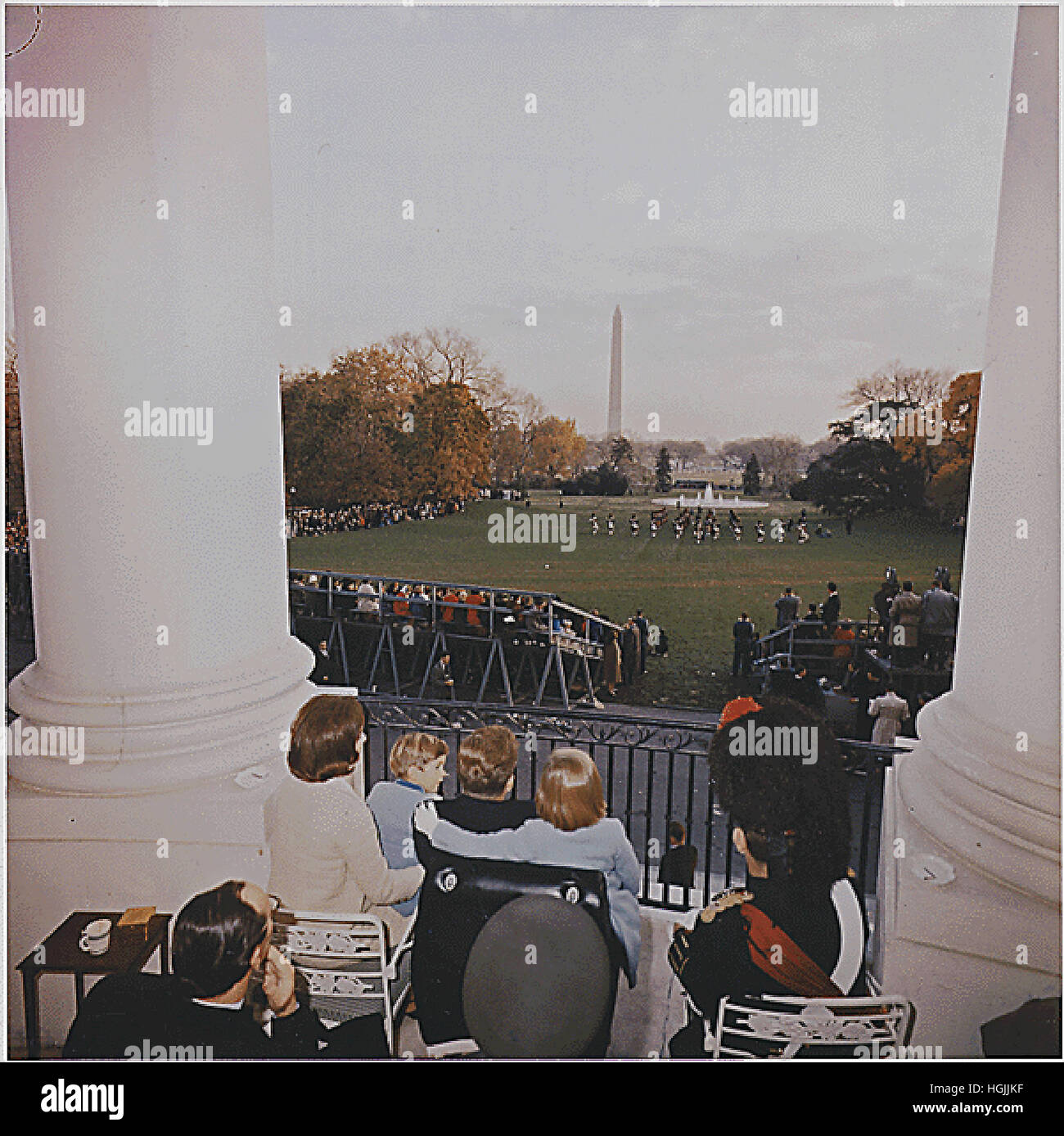 United States President John F. Kennedy and Family watch the Black Watch Tattoo perform on the South Lawn from the Truman Balcony of the White House in Washington, DC on November 13, 1963. First Lady Jacqueline Kennedy, John F. Kennedy, Jr., Caroline Kennedy, Major Wingate Gray, Ambassador of Great Britain David Ormsbey-Gore, spectators. Credit: White House via CNP - NO WIRE SERVICE - Photo: White House/Consolidated News Photos/White House via CNP Stock Photo