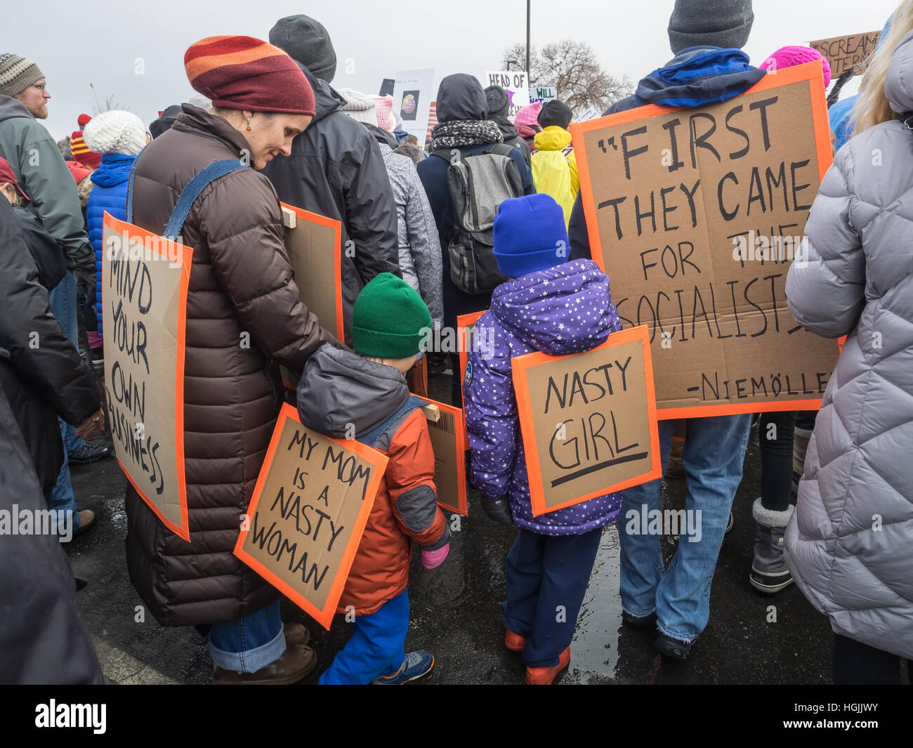 Saint Paul, Minnesota, USA. 21st January, 2017. A family participating in the Women's March wears a variety of political signs in St Paul, Minnesota. Cindy Carlsson/Alamy Live News Stock Photo