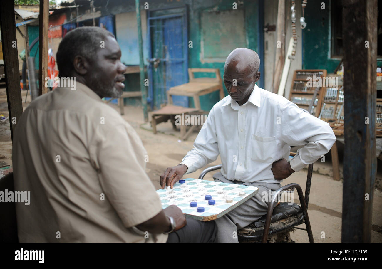 Two men play a board game in Lusaka, Zambia, 09 March 2016. Photo: Britta Pedersen/dpa-Zentralbild/ZB Stock Photo