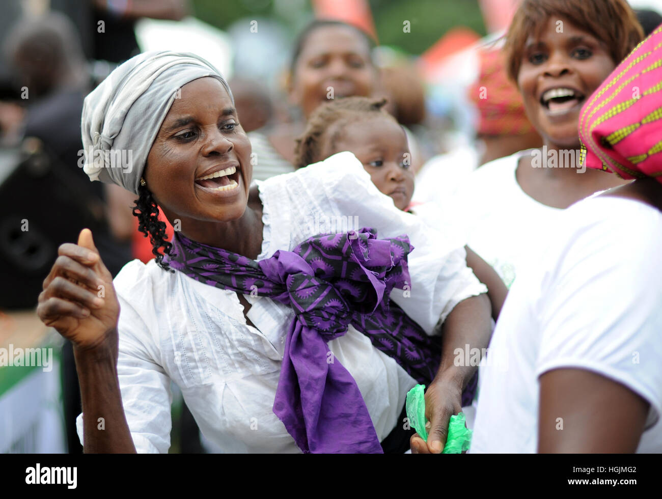 Lusaka, Zambia. 08th Mar, 2016. A women with an infant on her back dances at a celebration of International Women's Day in Lusaka, Zambia, 08 March 2016. Photo: Britta Pedersen/dpa-Zentralbild/ZB/dpa/Alamy Live News Stock Photo