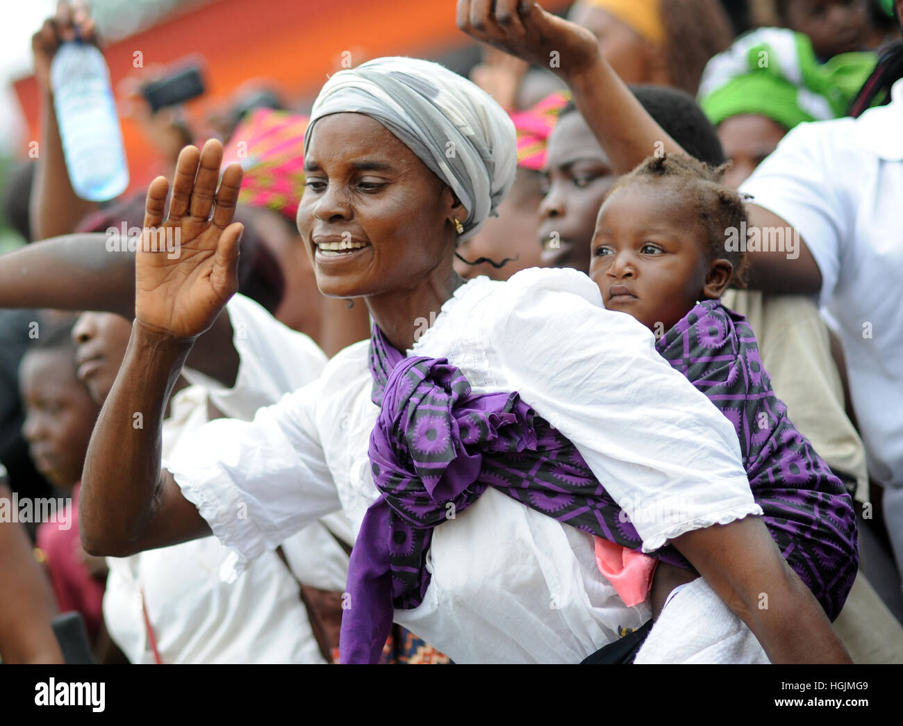 Lusaka, Zambia. 08th Mar, 2016. A women with an infant on her back dances at a celebration of International Women's Day in Lusaka, Zambia, 08 March 2016. Photo: Britta Pedersen/dpa-Zentralbild/ZB/dpa/Alamy Live News Stock Photo