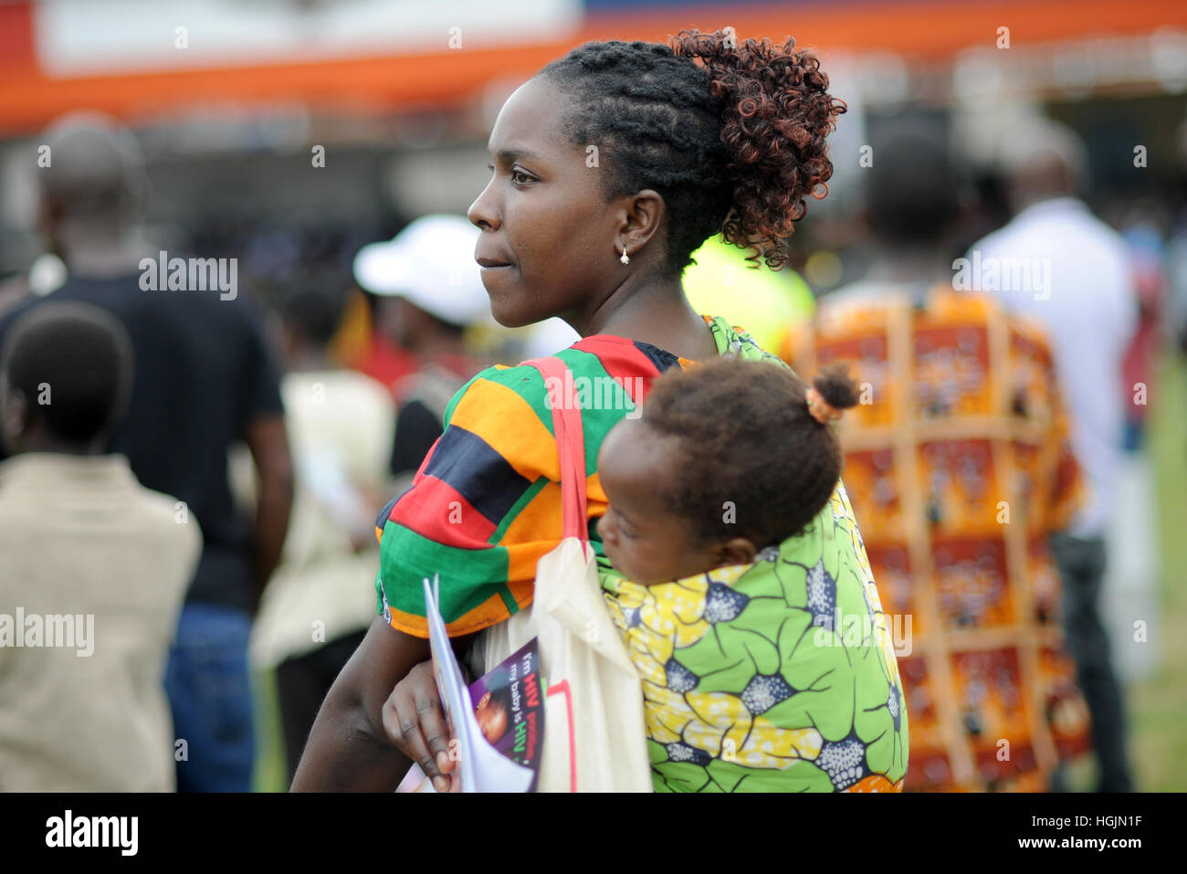 Lusaka, Zambia. 08th Mar, 2016. A women with an infant on her back at celebration of International Women's Day in Lusaka, Zambia, 08 March 2016. Photo: Britta Pedersen/dpa-Zentralbild/ZB/dpa/Alamy Live News Stock Photo