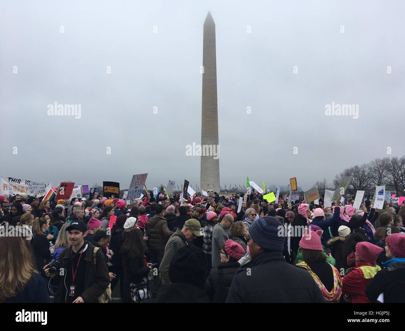 Crowds hold signs marching near the monument for the women's march. Stock Photo