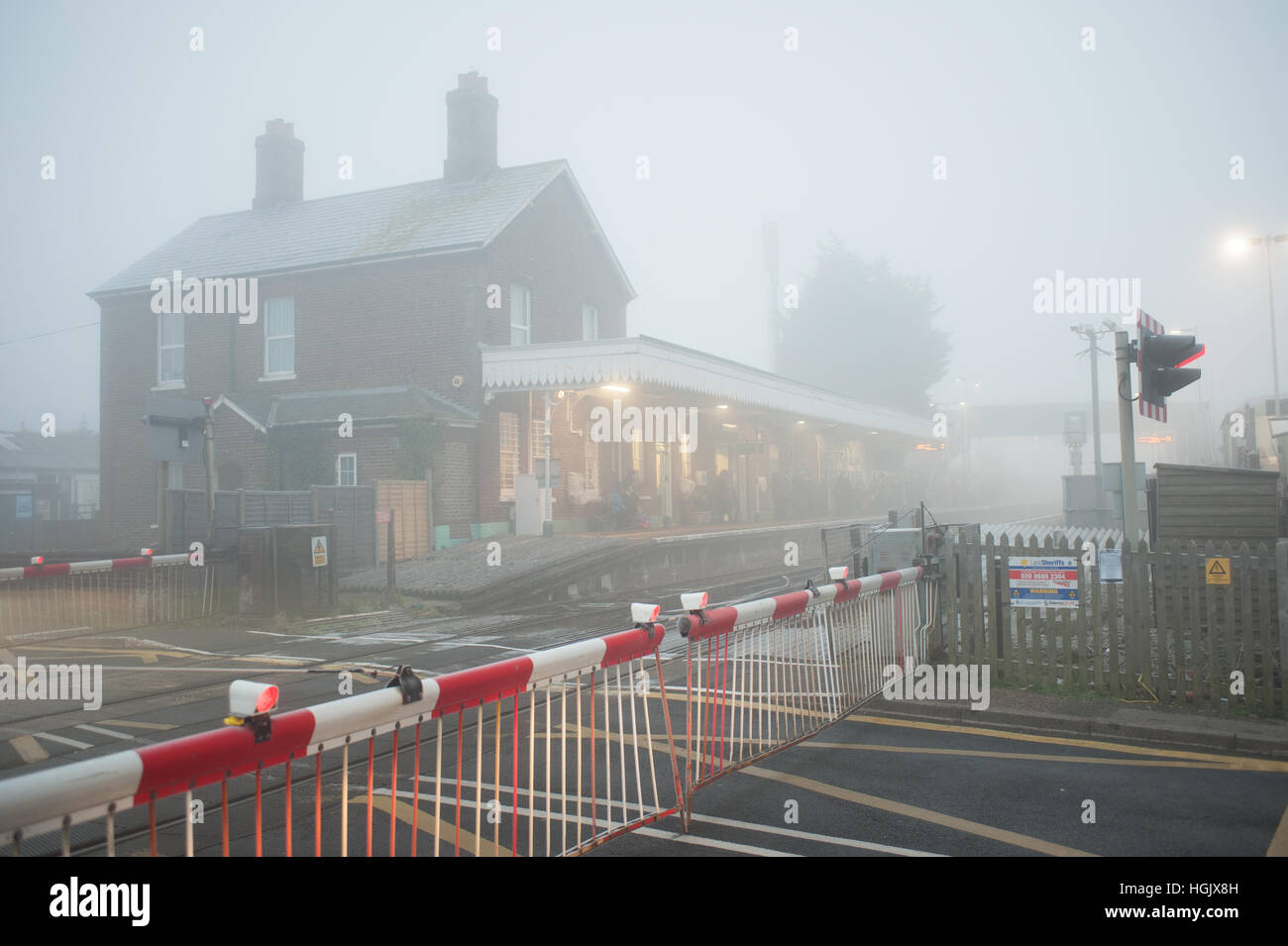 Railway level crossing gates closed at Angmering Train Station in West