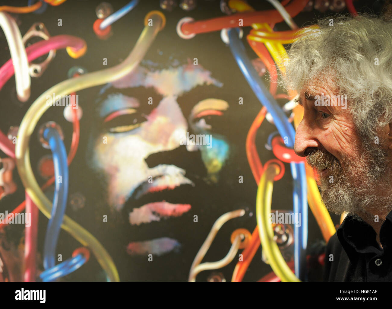 German graphic designer and sculptor Guenther Kieser stands in front of the poster for the Germany tour 1969 of singer Jimi Hendrix during the opening celebration of his exhibition 'Kieser, Plakate' at the Broehnan museum in Berlin, Germany, 20 January 2017. The Broehnan museum presents a show of the artist as part of the Blackbox series from 21 January until 23 July 2017. Photo: Roland Popp/dpa Stock Photo