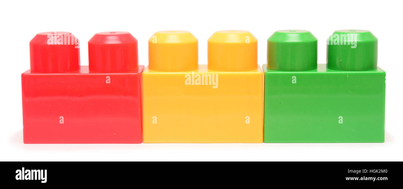 Colorful stacked toy plastic building blocks isolated on white ...