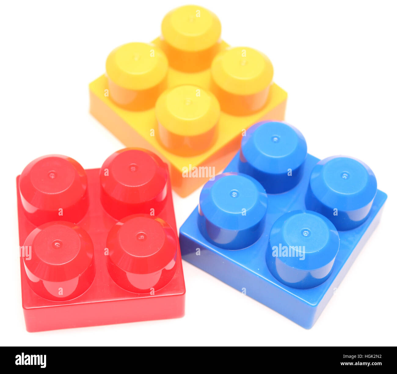Colorful stacked toy plastic building blocks isolated on white ...